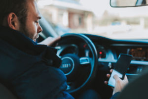 Man texting while driving