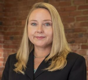 "Professional headshot of Abbigale Bricker, a dedicated attorney specializing in personal injury law, smiling confidently in a formal setting