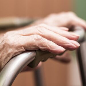 Elderly hands on a walker